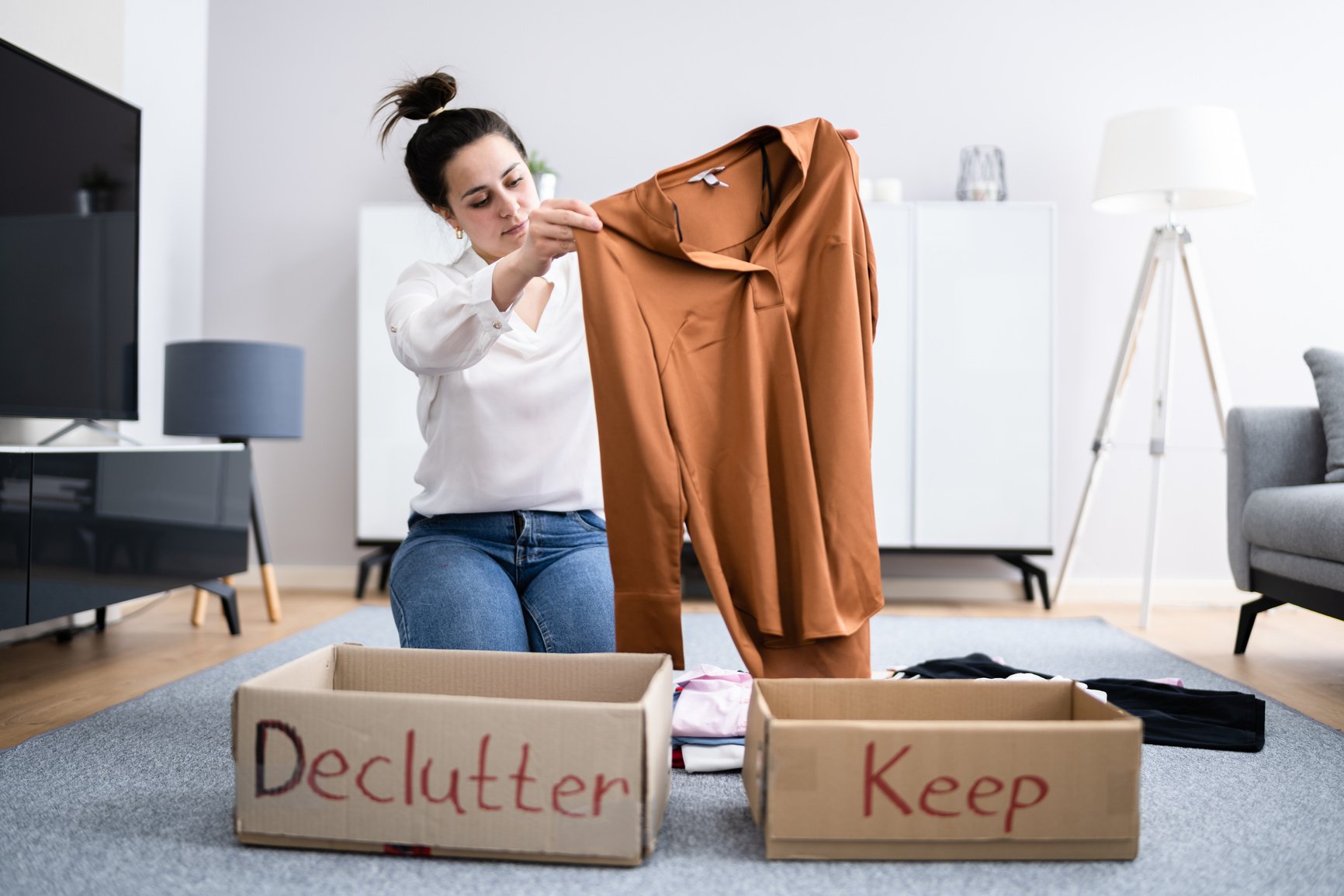 Woman Decluttering Clothes, Sorting